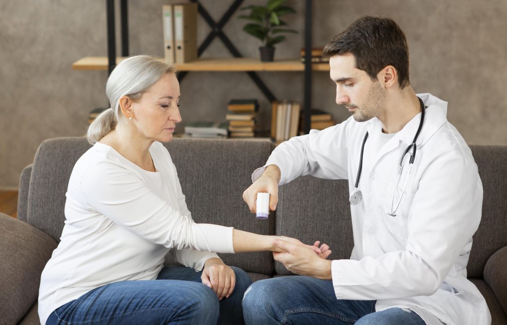 Power of genetic testing- an old elite female being tested with an expert young male health professional for biological testing in her living room.