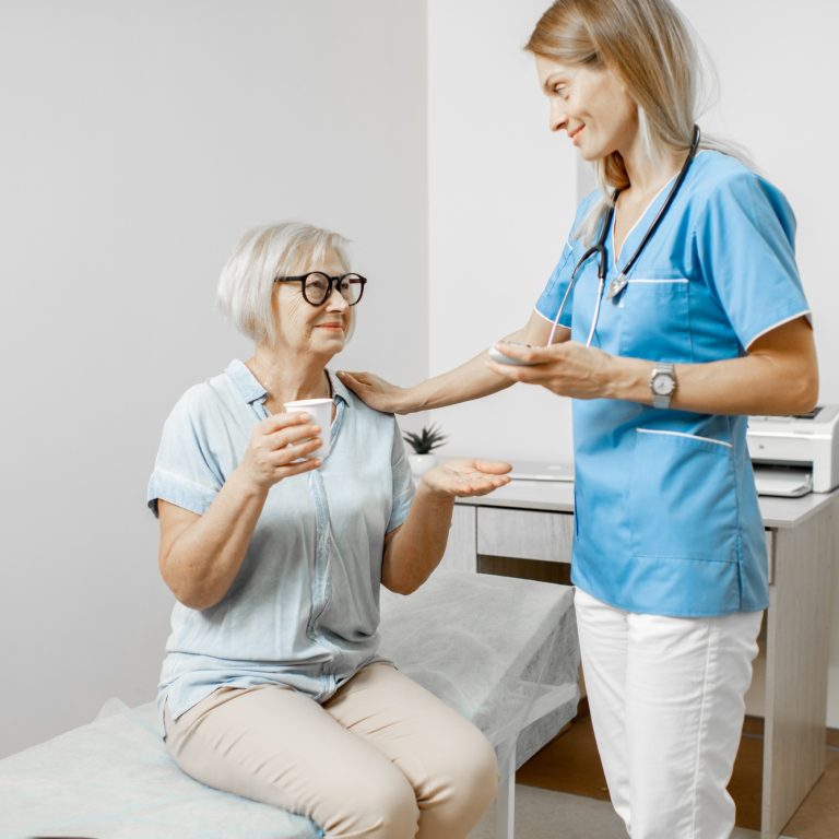 Medication Administration by nurse to senior patient.